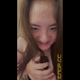 Emi squats over the toilet in a black top and pushes out a turd into her hand, then smiles for the camera as she picks apart her piece of shit with her fingers. Vertical format video. About 7.5 minutes.